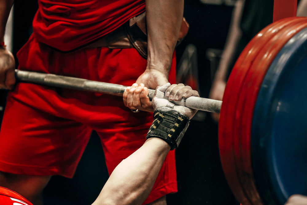 male athlete bench press at powerlifting competition