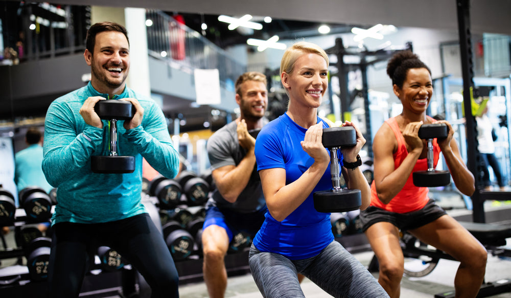 Premium Photo  Fitness happy and portrait of friends in gym for teamwork  support and workout motivation coaching and health with group of people  training in sports center for cardio exercise and