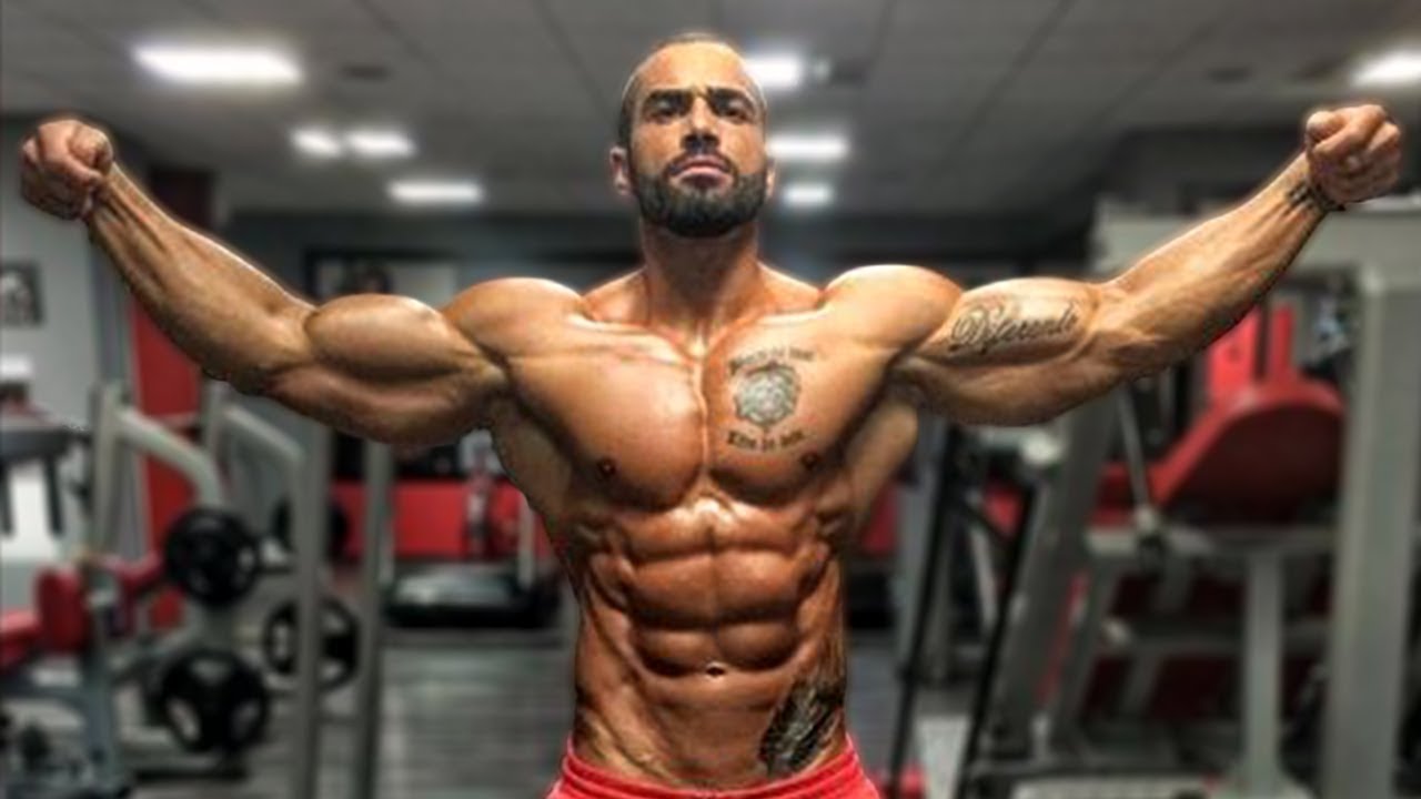 a fitness model showing his abs