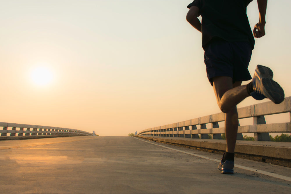 Man jogging on bridge road
