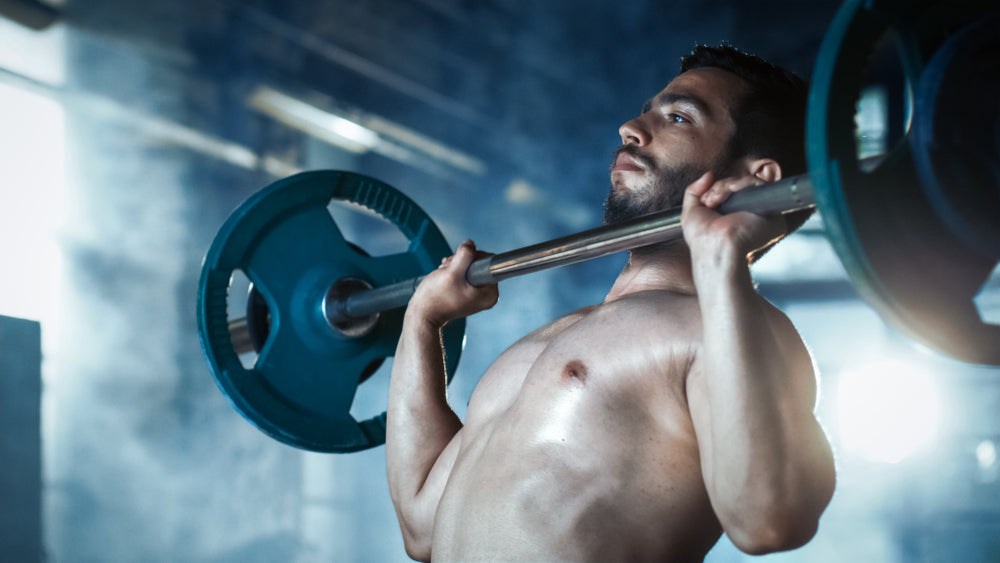 Close-up of a Muscular Shirtless Man Lifting Heavy Barbell and Doing Military Press 