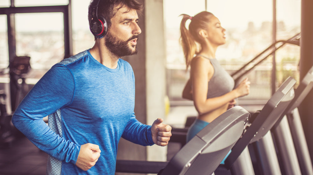 Couple working exercise on treadmill