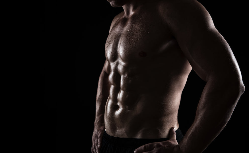 lose up of perfect male body isolated on black background