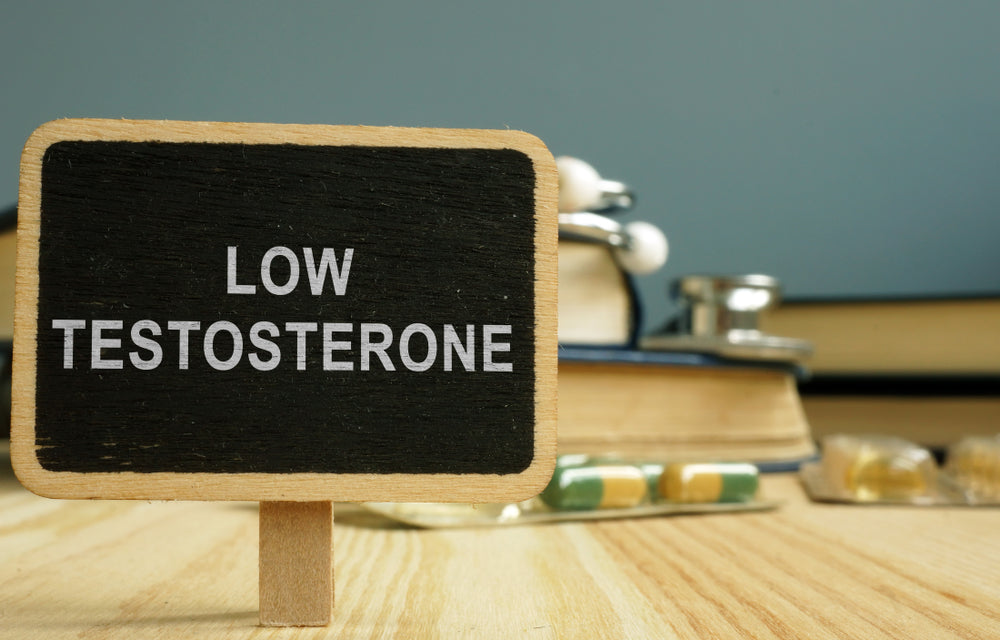 Sign low testosterone and book on wooden surface.