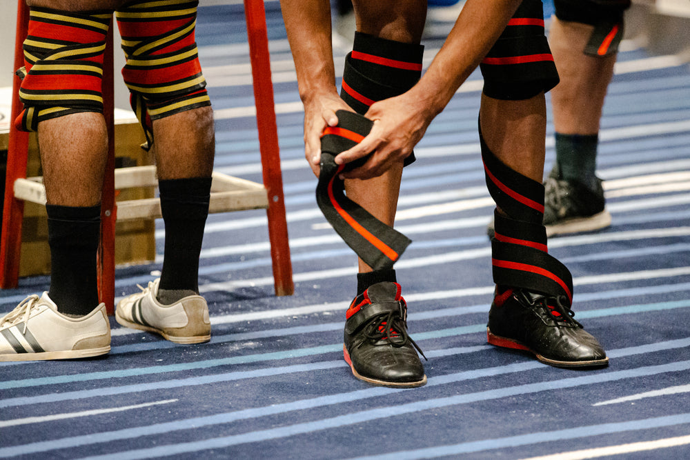 legs athlete powerlifter in knee wraps at powerlifting competition