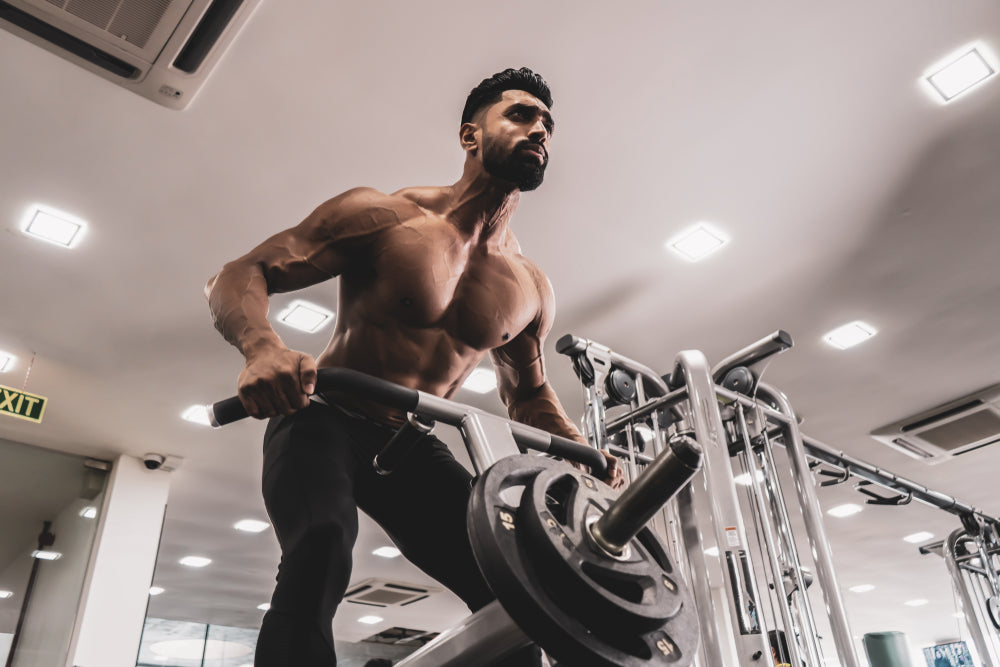 Man performing T bar rows for back muscles