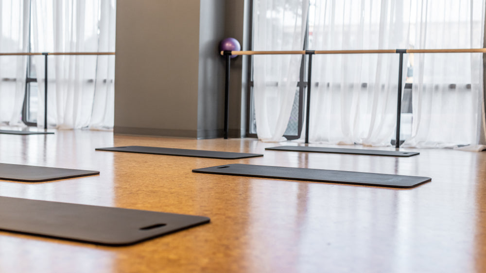 Empty workout barre studio with mats. 