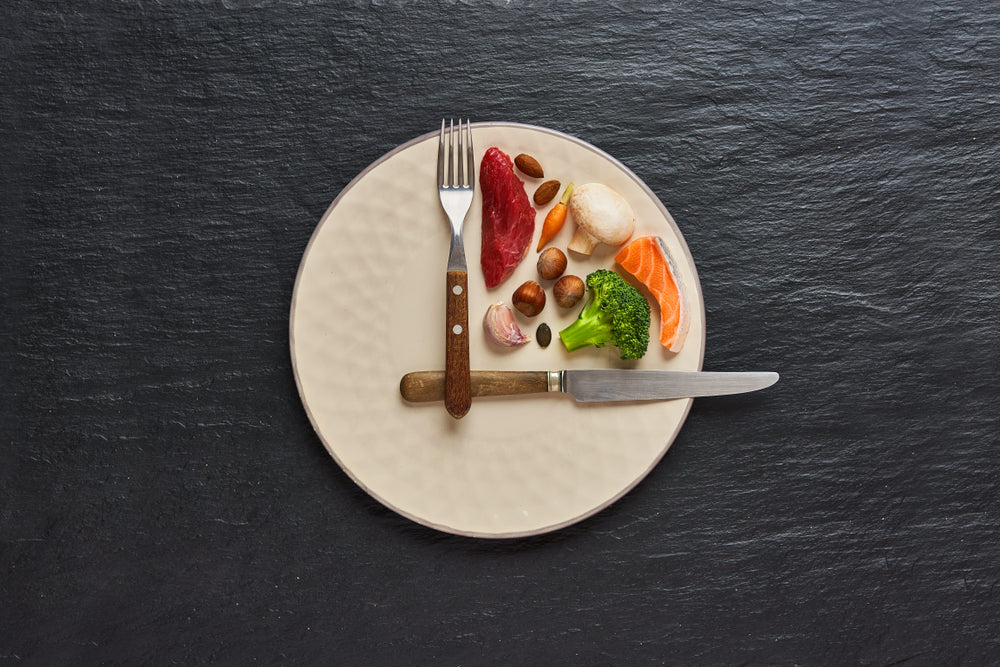 fasting diet concept. One third plate with healthy food and two third plate is empty. 