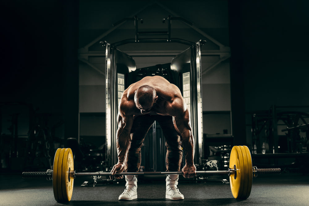  strong athletic rough man pumping up back muscles deadlift 