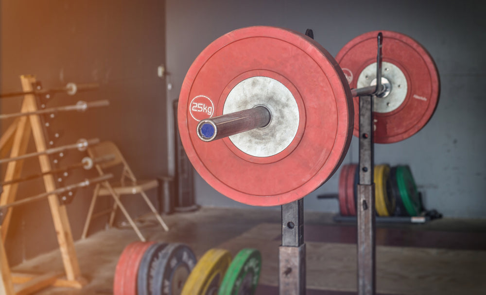 An olympic style weightlifting platform with weights on a bar.