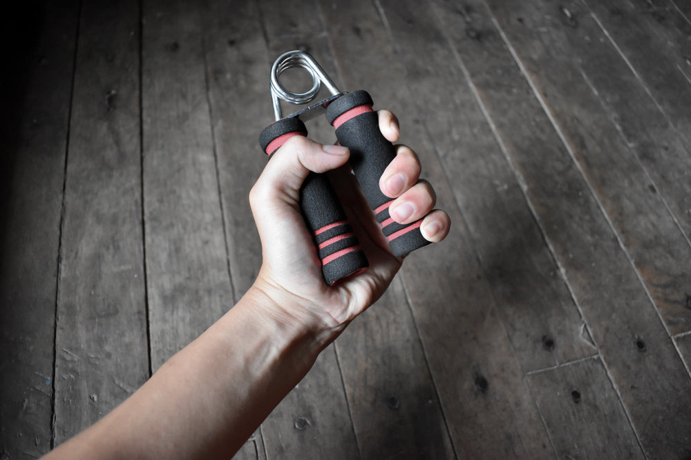 young man’s right hand gripping hand exercise gripper