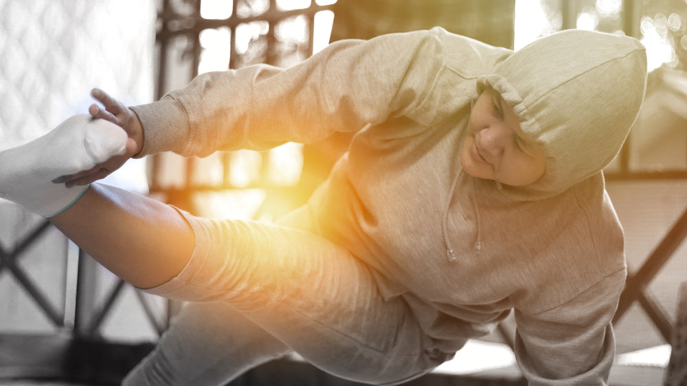 Close up portrait of Asian woman doing hard plank with toe touch oblique twist