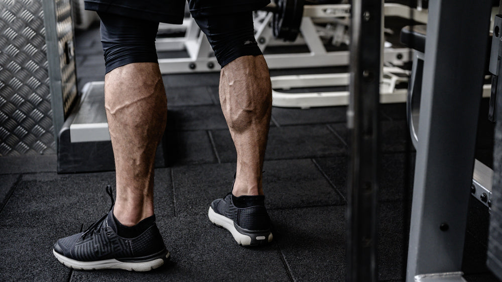 strong calves of young active athlete male in sneakers