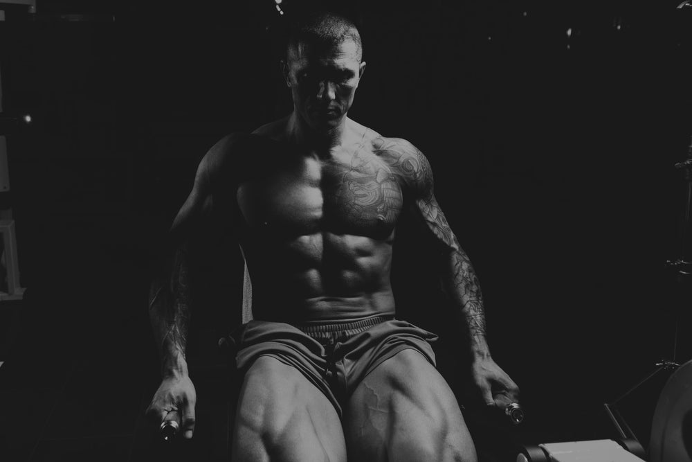 Strong Man In The Gym And Exercising Quadriceps