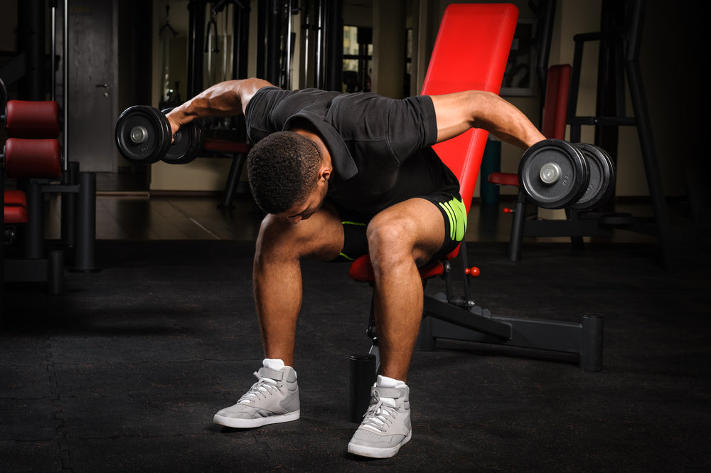  man doing Seated Bent Over Dumbbell Reverse Fly 