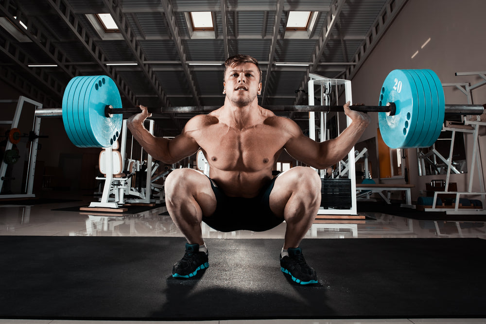 Professional athlete stands in front of a safety squat bar
