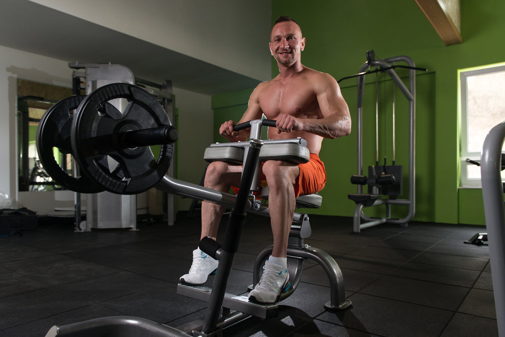 Bodybuilder Doing seated calf raise exercise in a gym