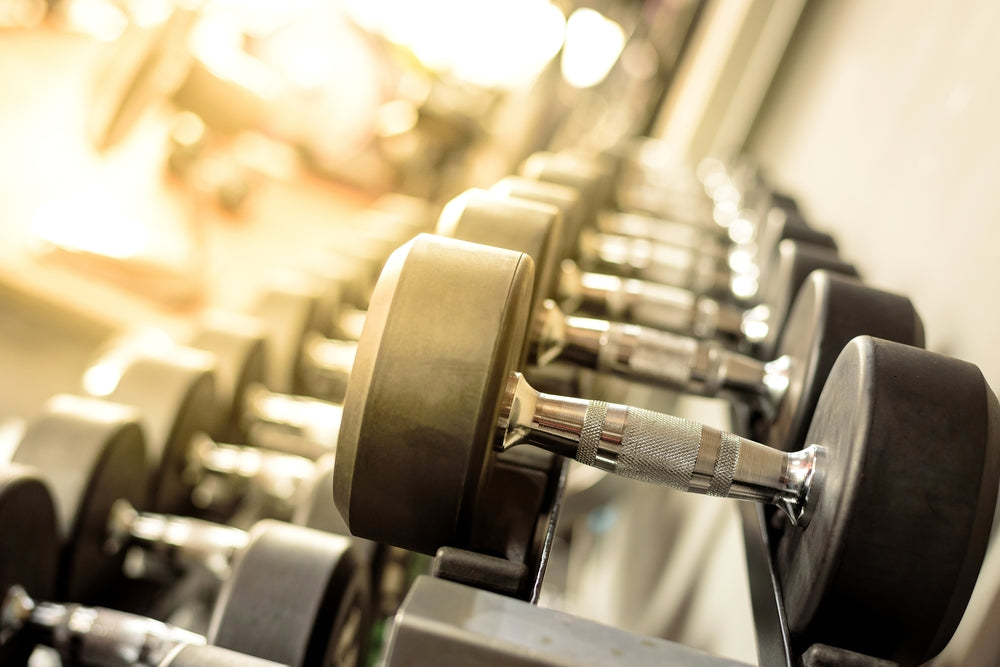  Close up many metal dumbbells on rack in sport fitness center
