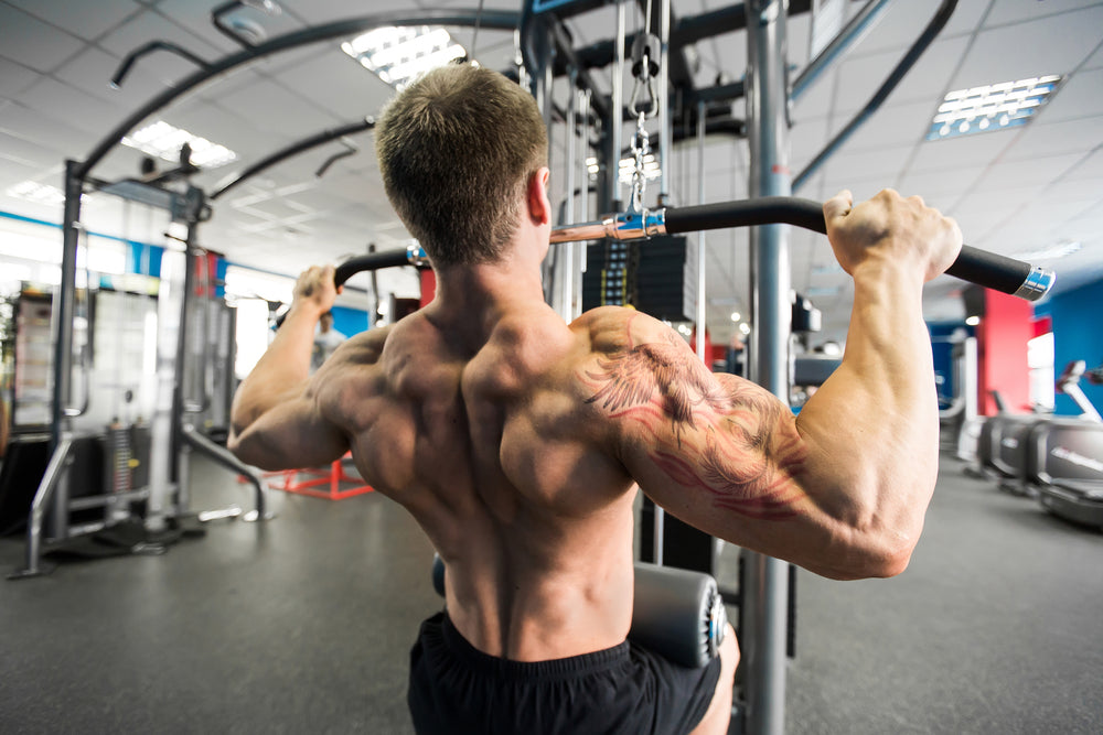 Fitness man working out lat pulldown training at gym