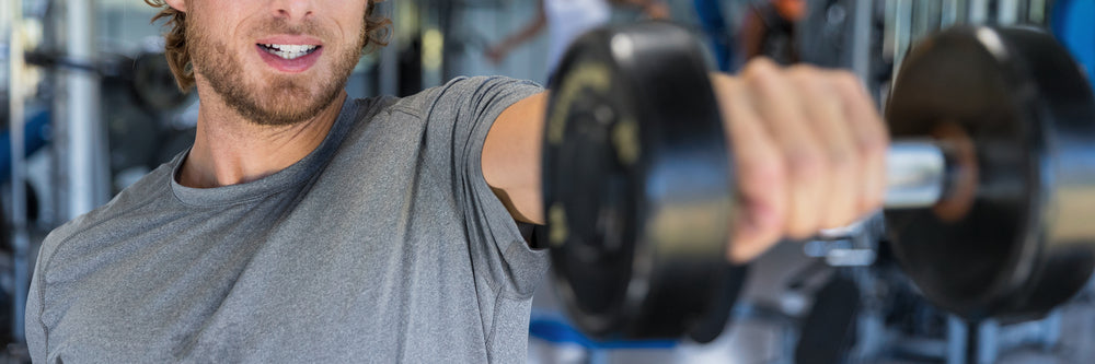 Athlete doing dumbbell front raise for shoulder workout