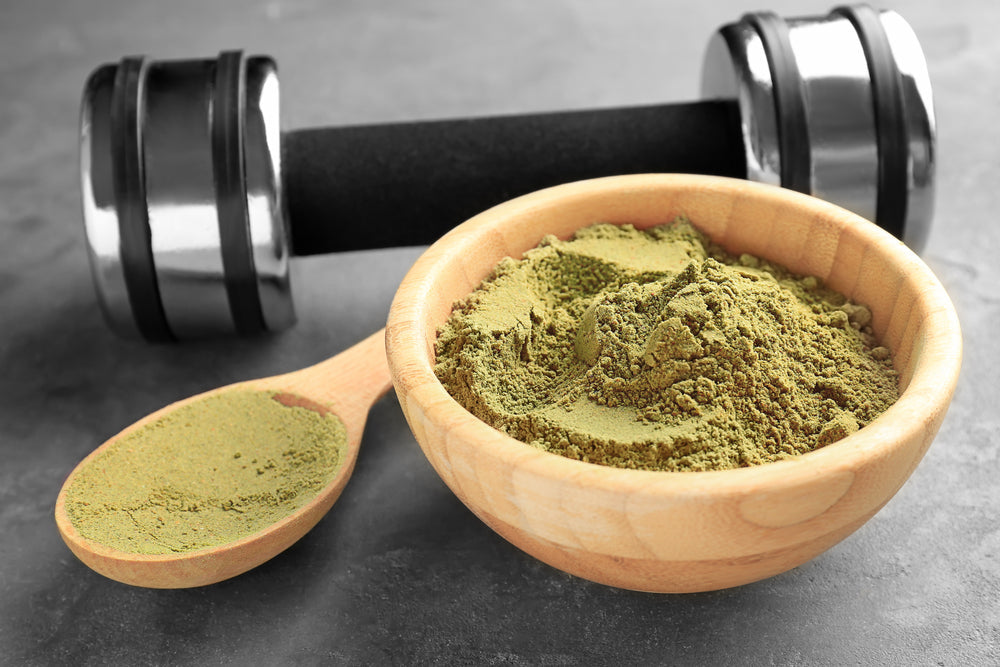 Wooden bowl and spoon of vegan protein powder on table