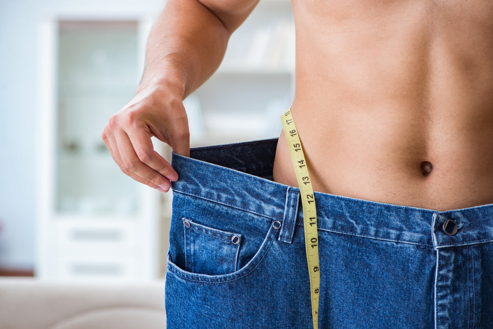 Man in oversized pants in weight loss concept