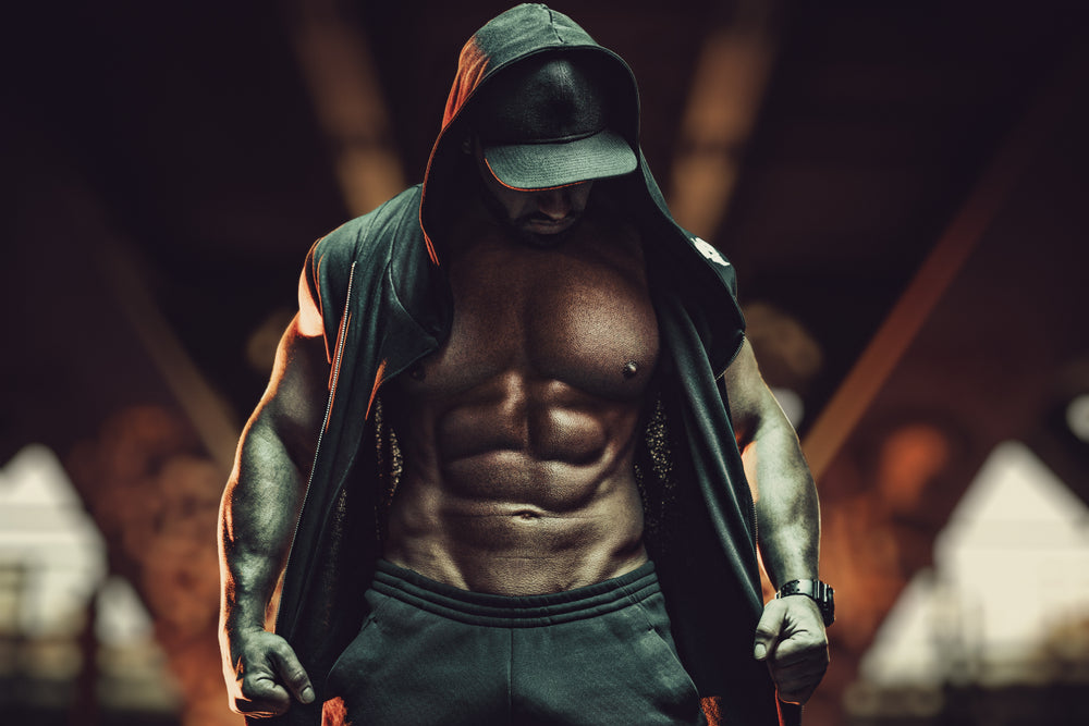 Young strong man bodybuilder with informal style clothing with hood 