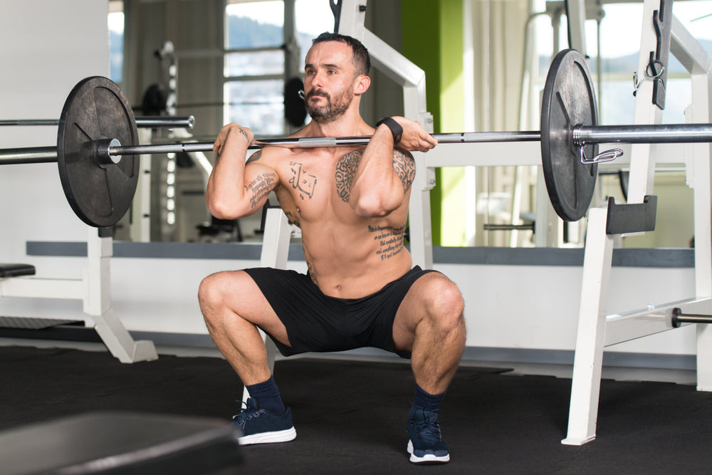 Man Working Out Legs With Barbell In A Gym - Front Squat Exercise