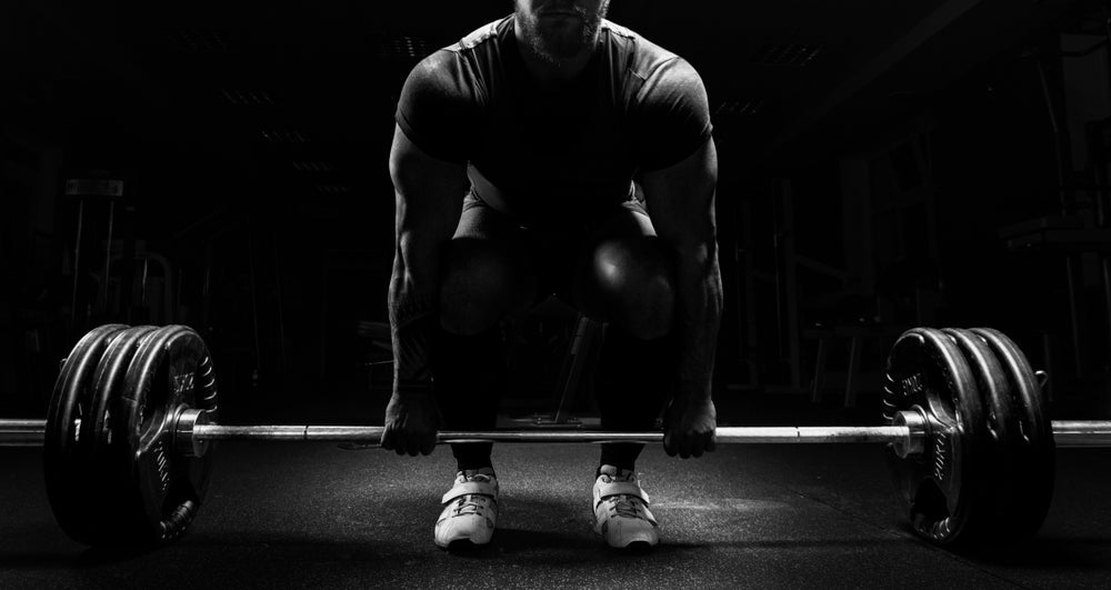 man is preparing to do a deadlift