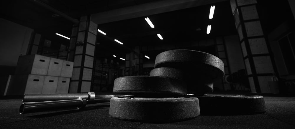 weights and gym equipment on the floor at fitness box 