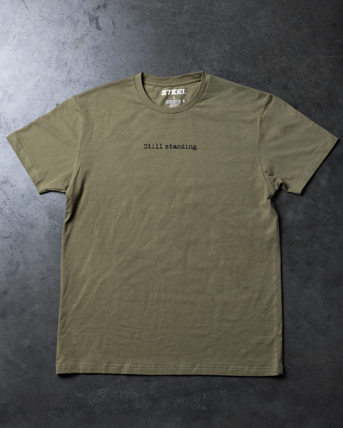 Steel Supplements Apparel S / Military Green Still Standing Typewriter Tee
